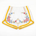 Shorts Estate DELAMIA — ghirlanda floreale multicolore con bordo giallo, vista frontale