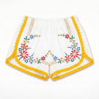 Shorts Estate DELAMIA — ghirlanda floreale multicolore con bordo giallo, vista frontale