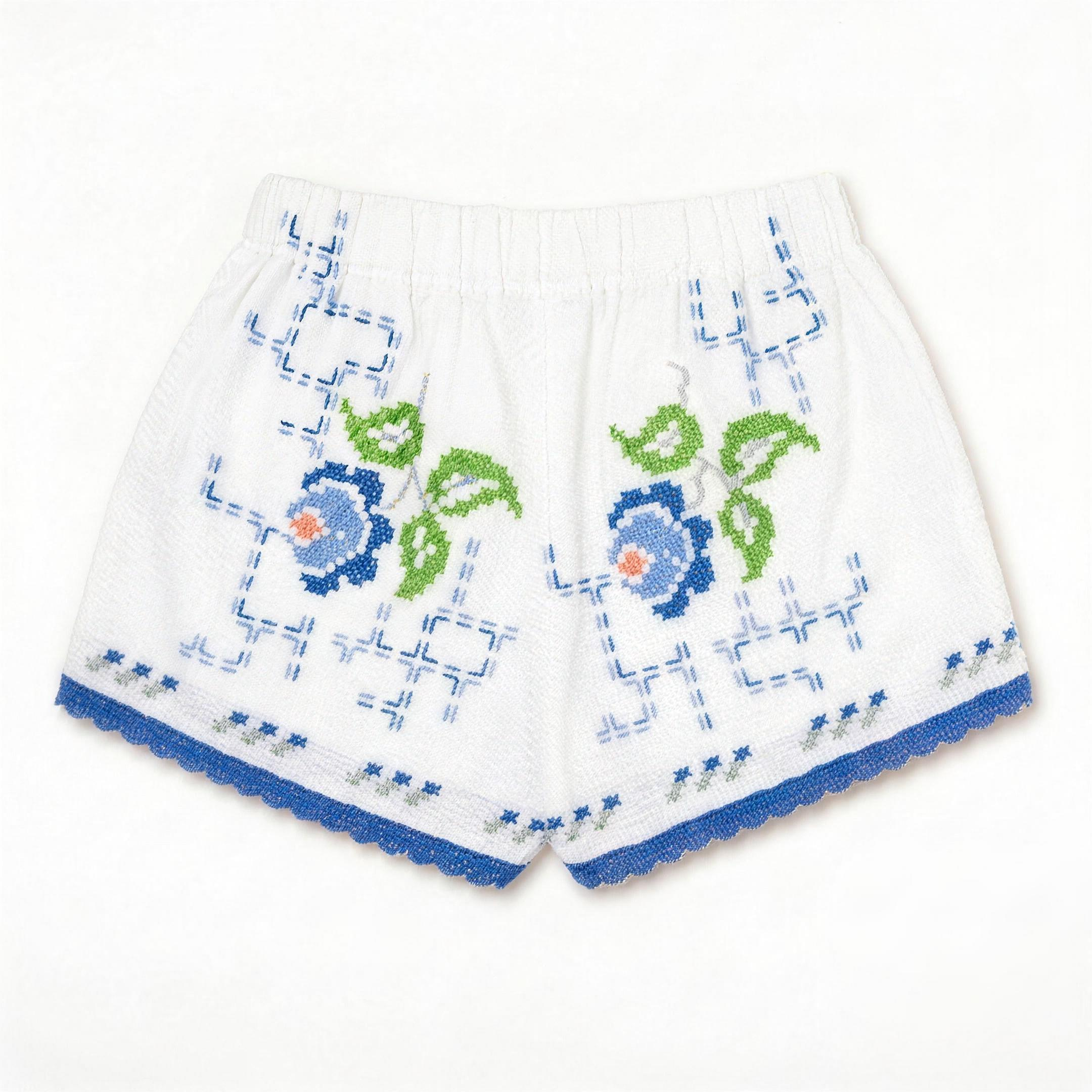 Shorts Verzura I DELAMIA — vista posteriore con foglie verdi e fiori