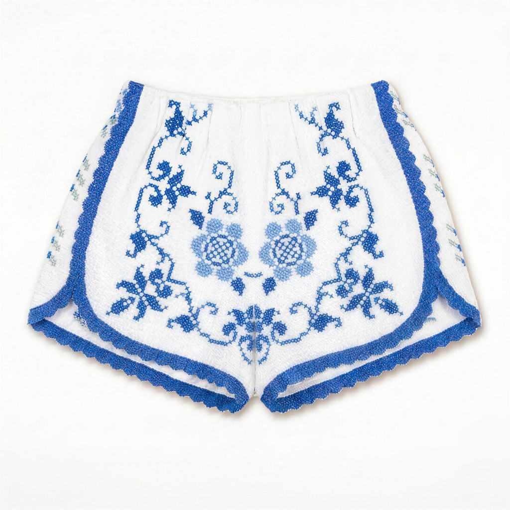 Shorts Adriatico DELAMIA — ricamo floreale blu cobalto su cotone bianco, vista frontale