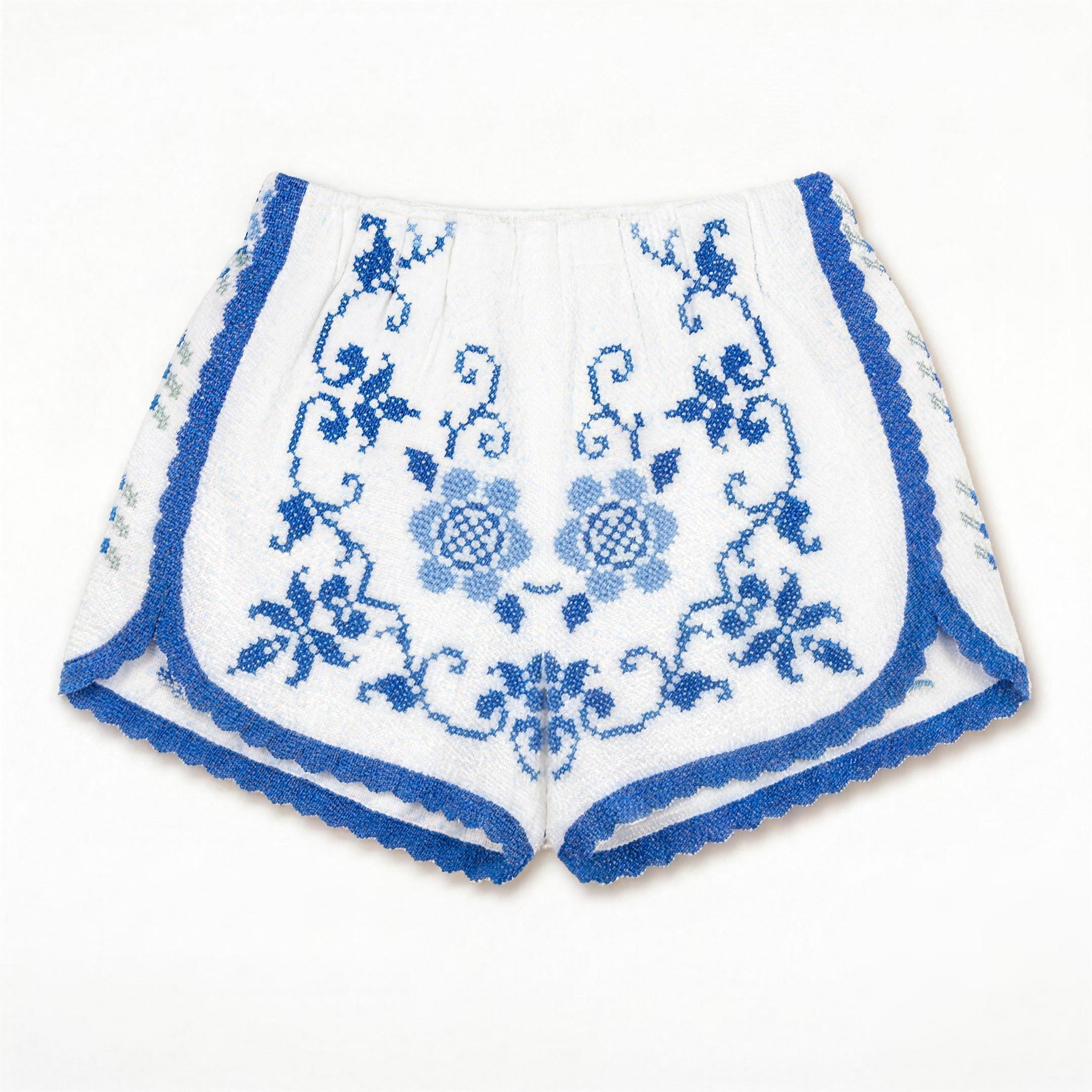 Shorts Adriatico DELAMIA — ricamo floreale blu cobalto su cotone bianco, vista frontale