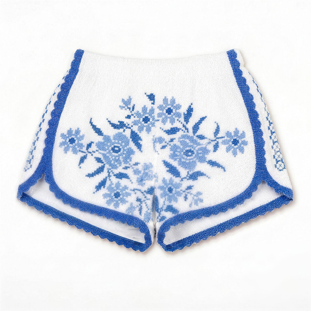 Shorts Ortensia DELAMIA — fioritura azzurra a punto croce su bianco, vista frontale
