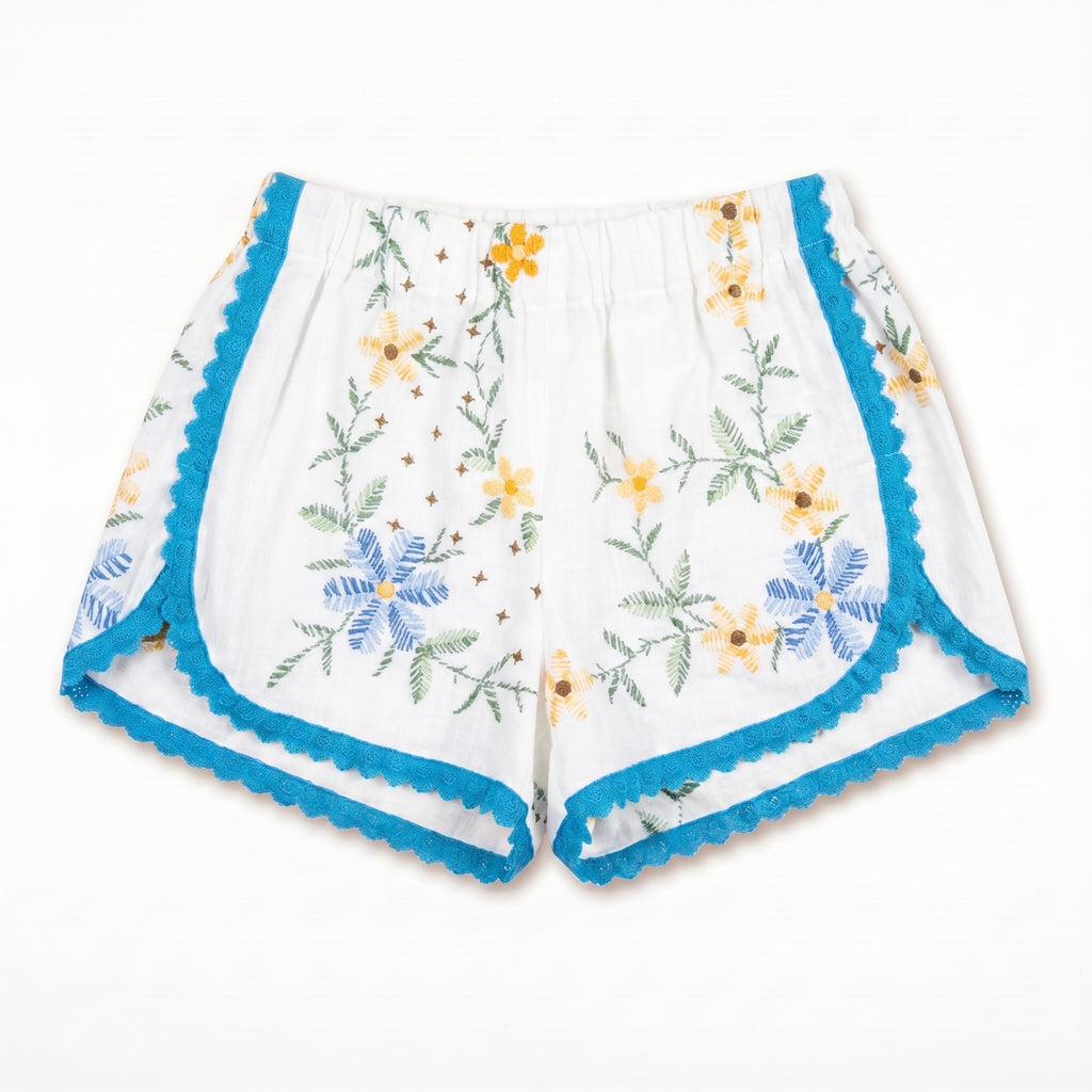 Shorts Maiolica DELAMIA — ricamo azzurro, giallo e verde con bordo turchese, vista frontale