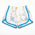Shorts Maiolica DELAMIA — ricamo azzurro, giallo e verde con bordo turchese, vista frontale