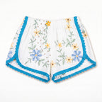 Shorts Maiolica DELAMIA — ricamo azzurro, giallo e verde con bordo turchese, vista frontale