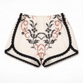 Shorts Vespro DELAMIA in lino panna con ricamo a punto croce nero e accento terracotta — vista frontale